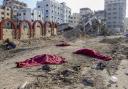Bodies of Palestinians who were killed in the Israeli bombardment of the Gaza Strip are covered on the main road in Gaza City on Tuesday, January 2. Photo: AP.
