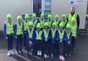 Ian Corrigan, Encirc pictured with the pupils from St. Columban’s PS, Belcoo after they received their high-visibilty vests and beanie hats.