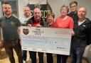 Pictured presenting a cheque for £2,150 are Mark Loughran (The Perfect Pint), Fabian McGlone (quiz master), Colin Bell (The Kevin Bell Repatriation Trust), Geraldine Wilson, Eileen McKenna, David McKenna and Paul McKenna (quiz organisers).