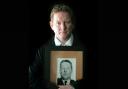 Stephen Gault holds a picture of his late father who was killed in the Enniskillen Bomb.
