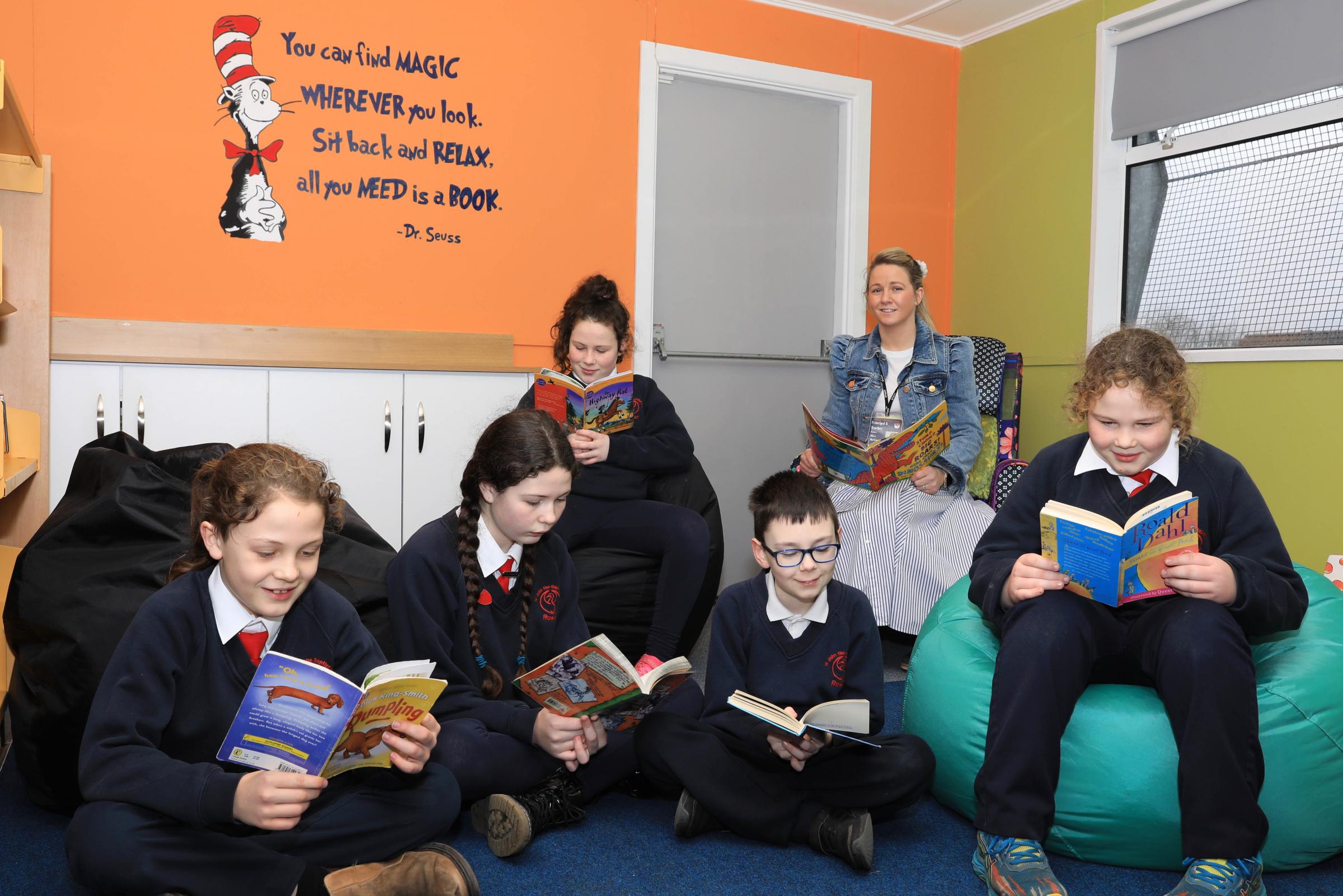 Principal Aideen McGarrigle with pupils Francis Crumlish, Lourdes Crumlish, Vanessa Crumlish, Reese ODonoughue and Johnie Crumlish enjoying some reading time in their new library/ICT suite