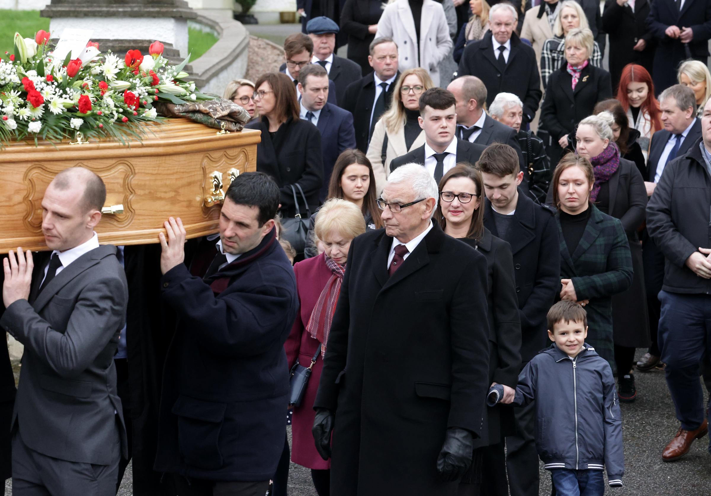 Family and friends follow the remains of The Late Ivan Henry.