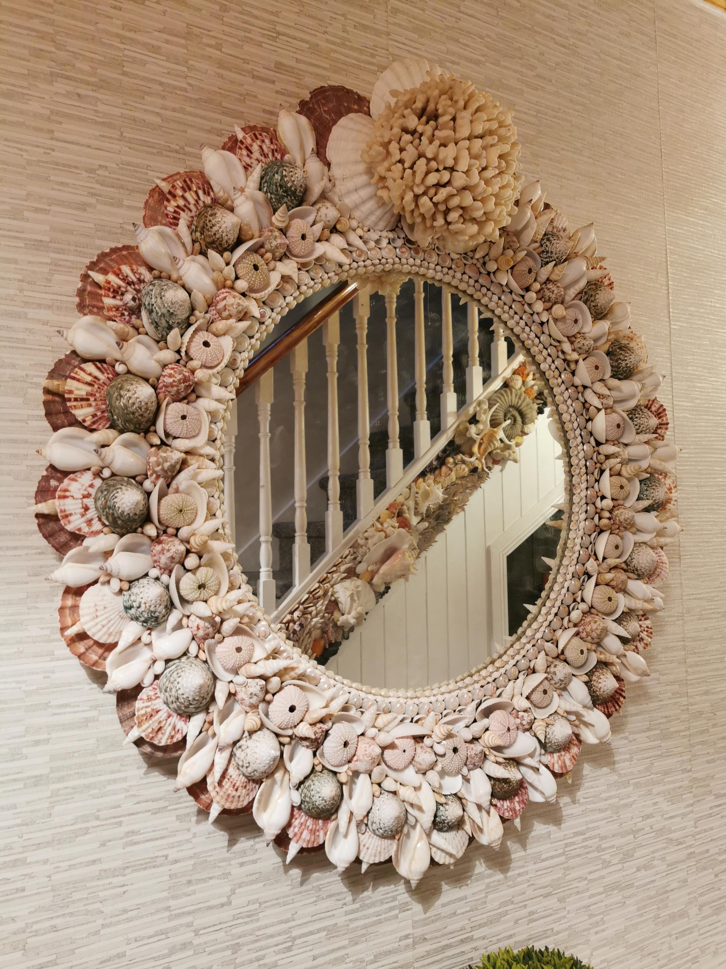 Coastal creations giant coral mirror with shell staircase in reflection.