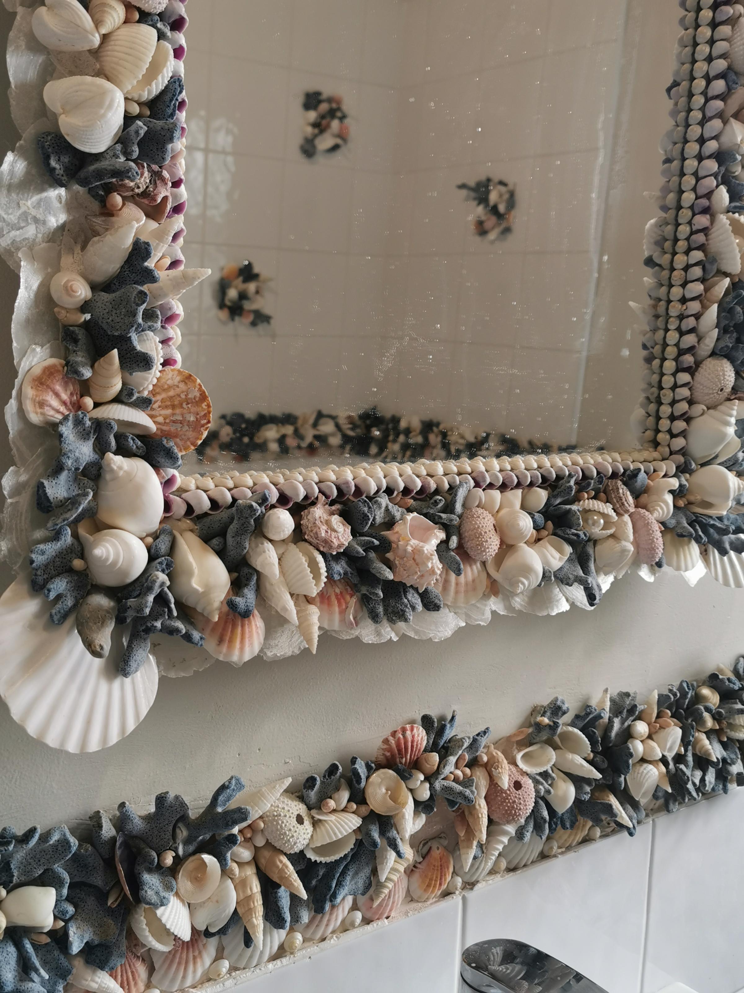 Blue coral bathroom feauting scallops, pink urchins, white conch shells and lots of vintage blue coral.