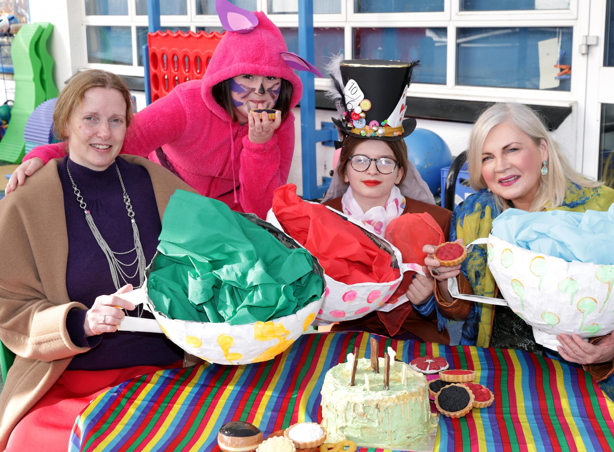 Mrs Sandra Isherwood, Principal, (left), with Keira Hatton, (Cheshire Cat), Kara-Lily Boyd, (Mad Hatter) and Noelle McAlinden, Artist.