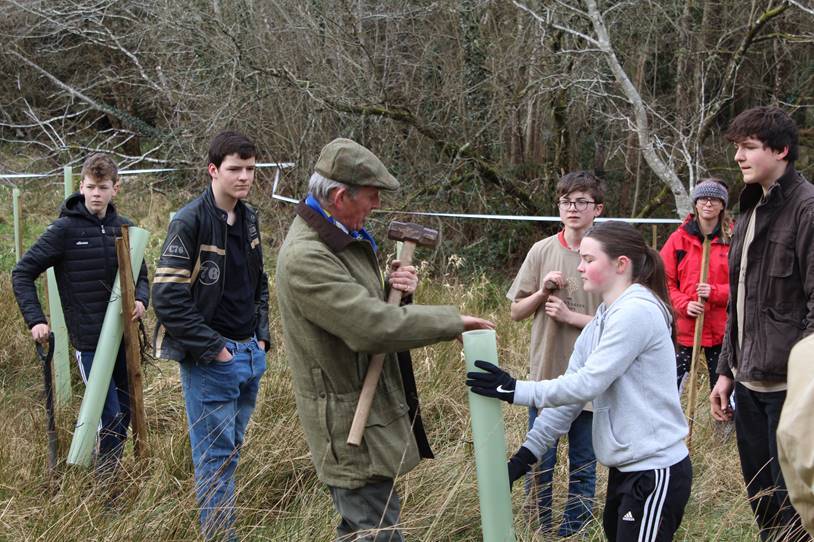 Viscount Brookeborough KG KStJ, demonstrating and explaining to the cadets and CFAVs his tips for tree planting.