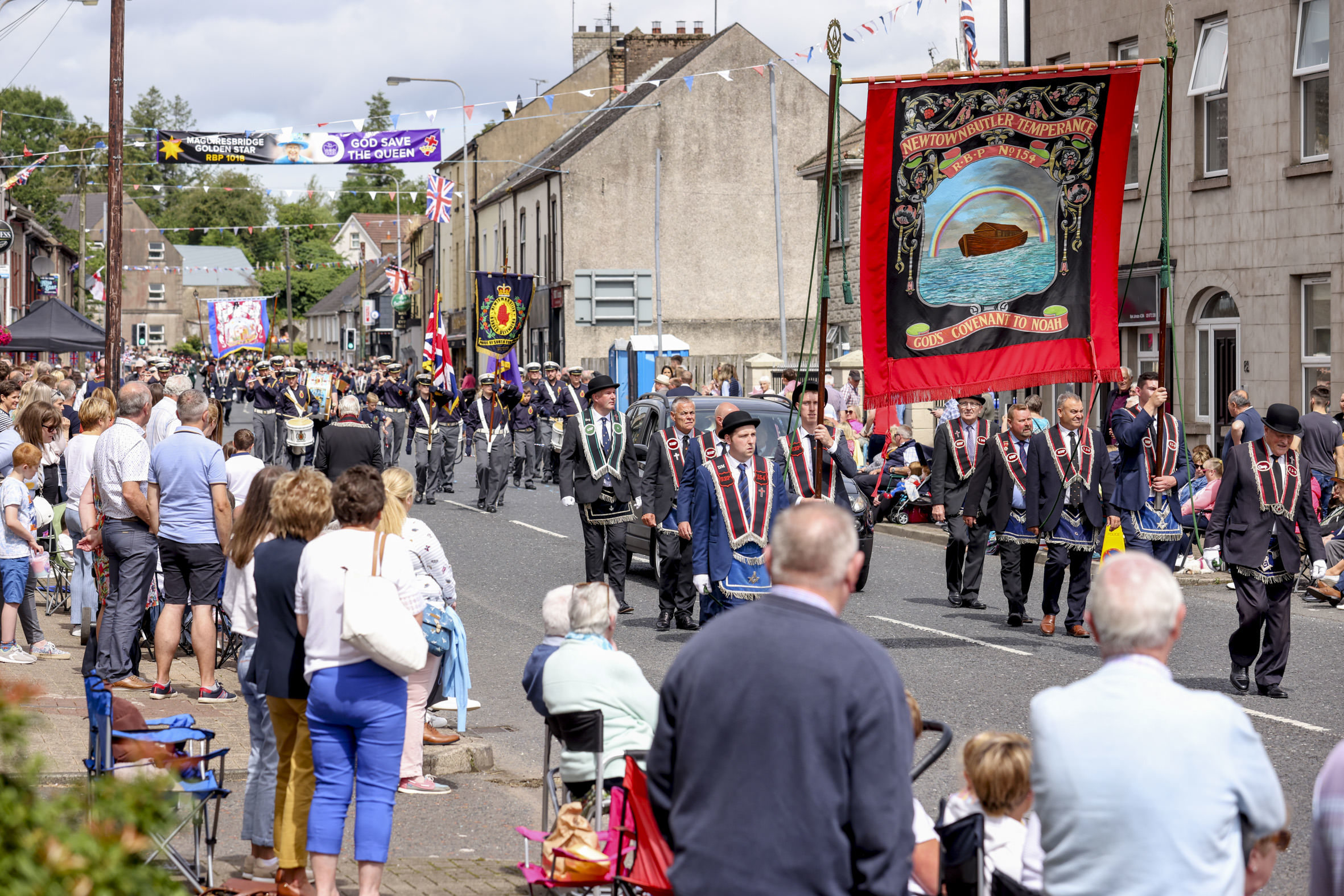 A fine view down the street of the busy scenes as bands marched along in front of many onlookers.