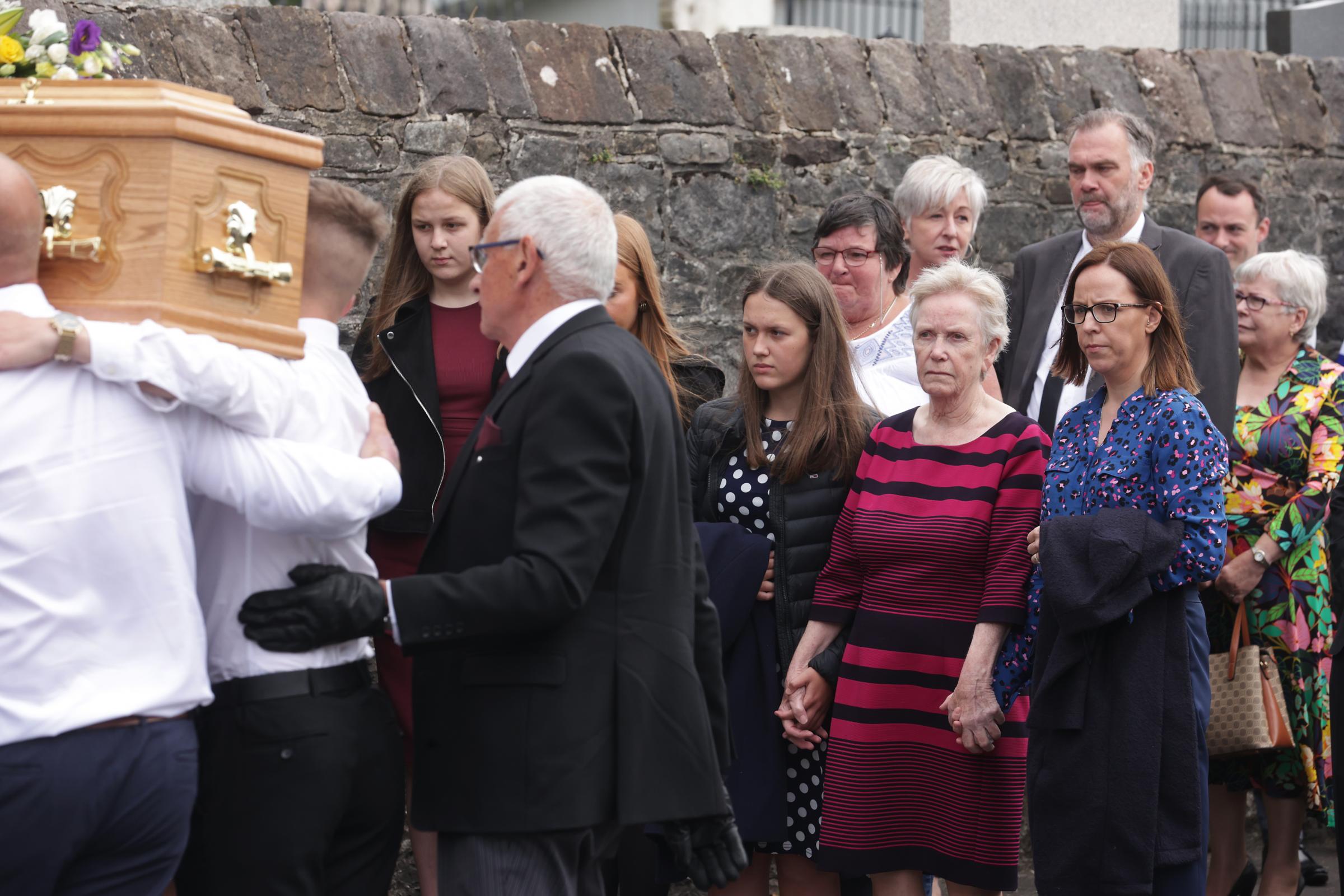 Family and friends look on as the remains of the late William Lyons is carried into St.Johns Parish Church, Fivemiletown.