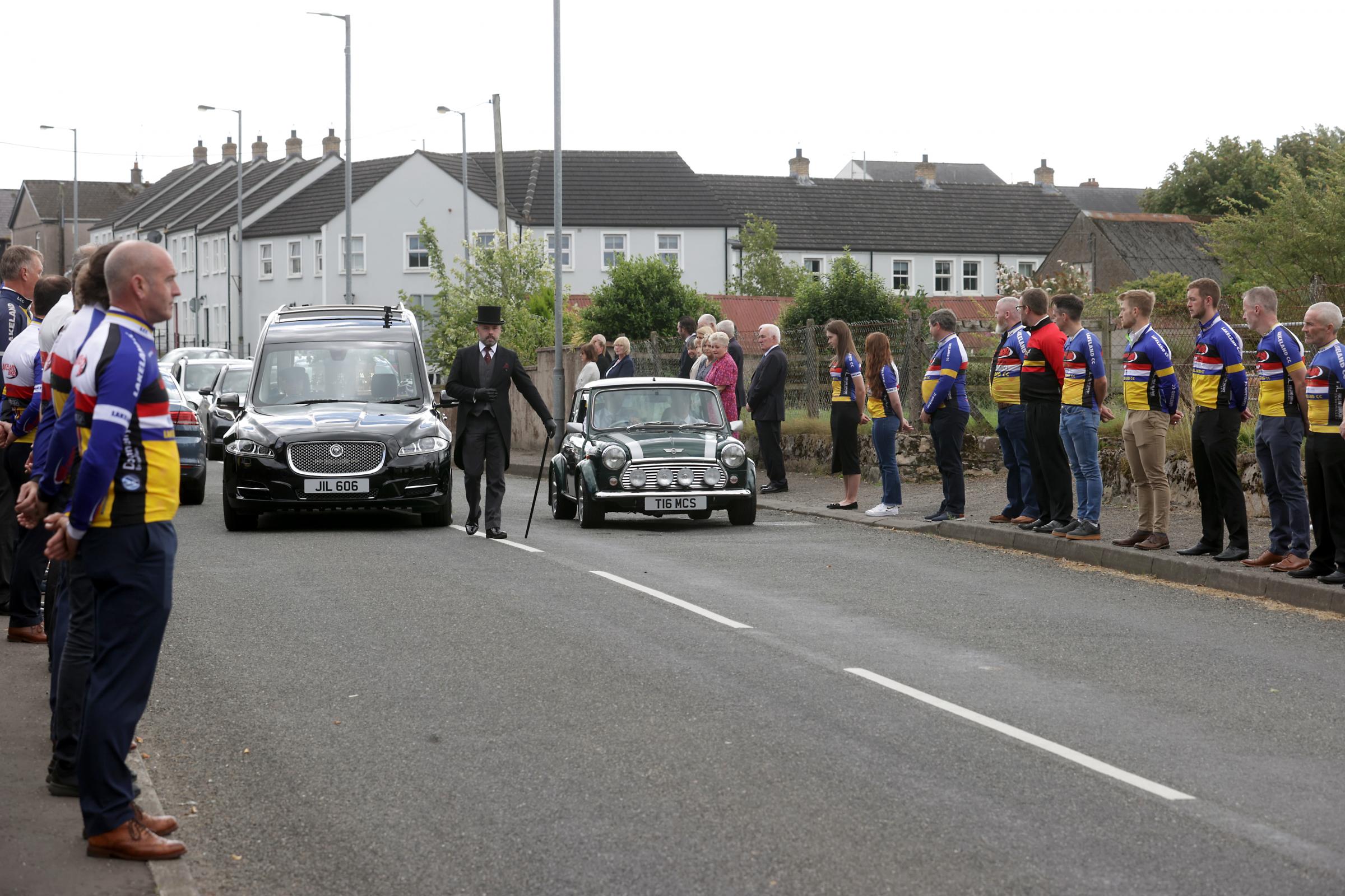 Members of Lakeland Cycle Club, line the route to pay their respects during the funeral of the late William Lyons.
