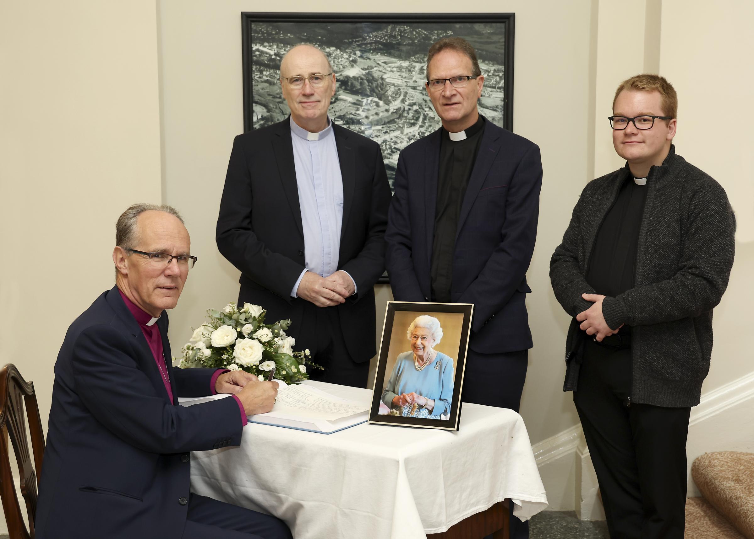 The Bishop of Clogher, the Right Revd Dr Ian Ellis, signs the book of condolences in memory of Her Majesty, Queen Elizabeth II. Also included are Right Rev. Monsignor, Peter OReilly, The Very Rev. Dean, Kenneth Hall and Rev. Chris West, Curate.