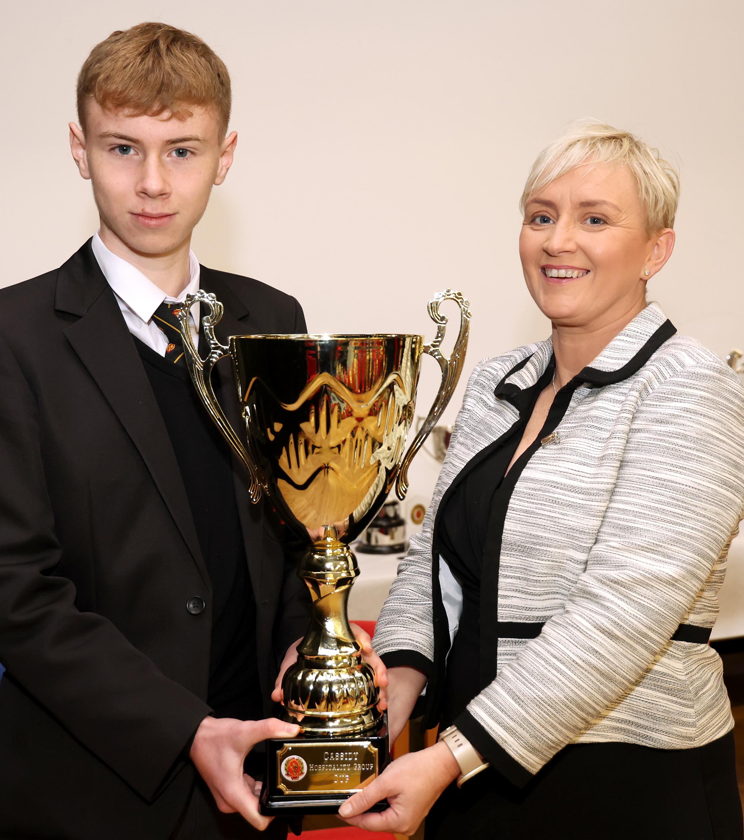 Joe Palmer, Top Achiever GCSE, receiving his cup from Helena Palmer, Principal.