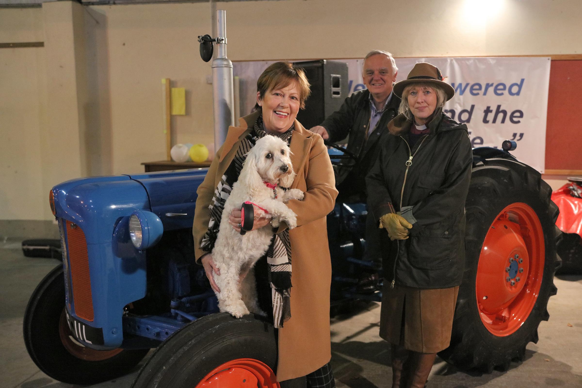 Heather Carson and her dog, Tilly, join Roy and Rev. Lorna Dreaning for the Harvest Service at Enniskillen Farmers Mart.