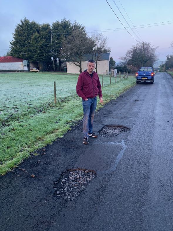 Councillor Eamon Keenan highlighting potholes on Grogey Road, Moan’s Cross, Fivemiletown.