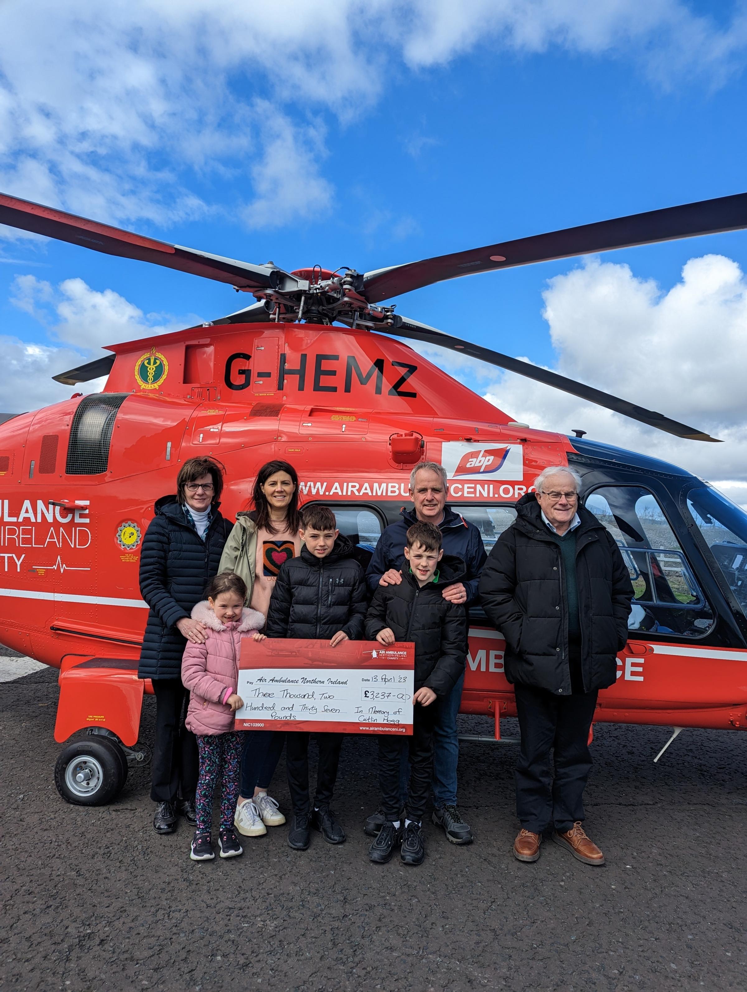 The Hogg family pictured with the Air Ambulance NI helicopter.