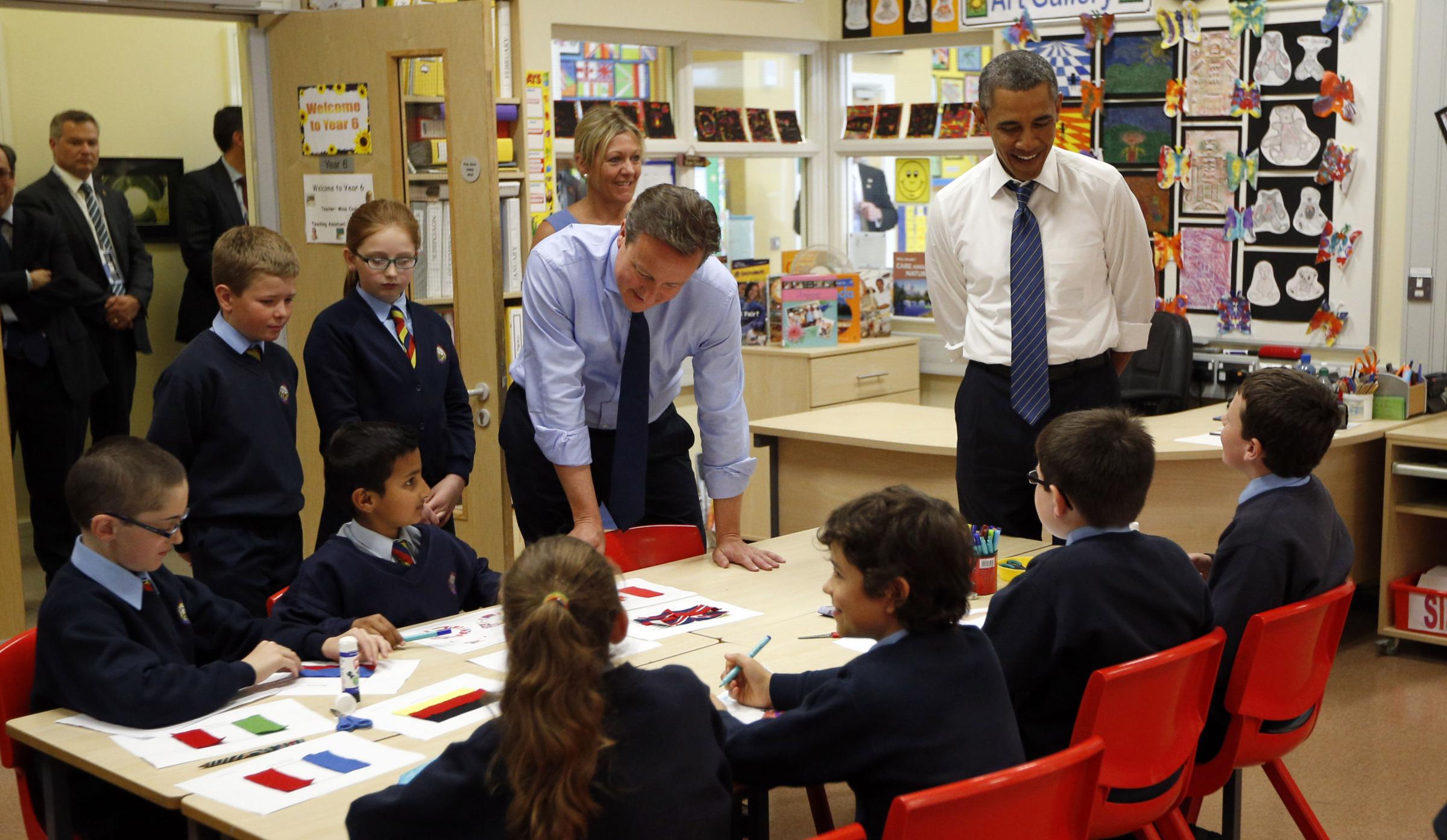 President Barack Obama and Prime Minister David Cameron watch as students work on a school project about the G8 summit during a visit to the Enniskillen Integrated Primary School in Enniskillen, Northern Ireland ahead of the G8 summit.