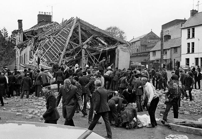 The scene of devastation in the moments following the Enniskillen bomb as rescuers try to pull people from the rubble.