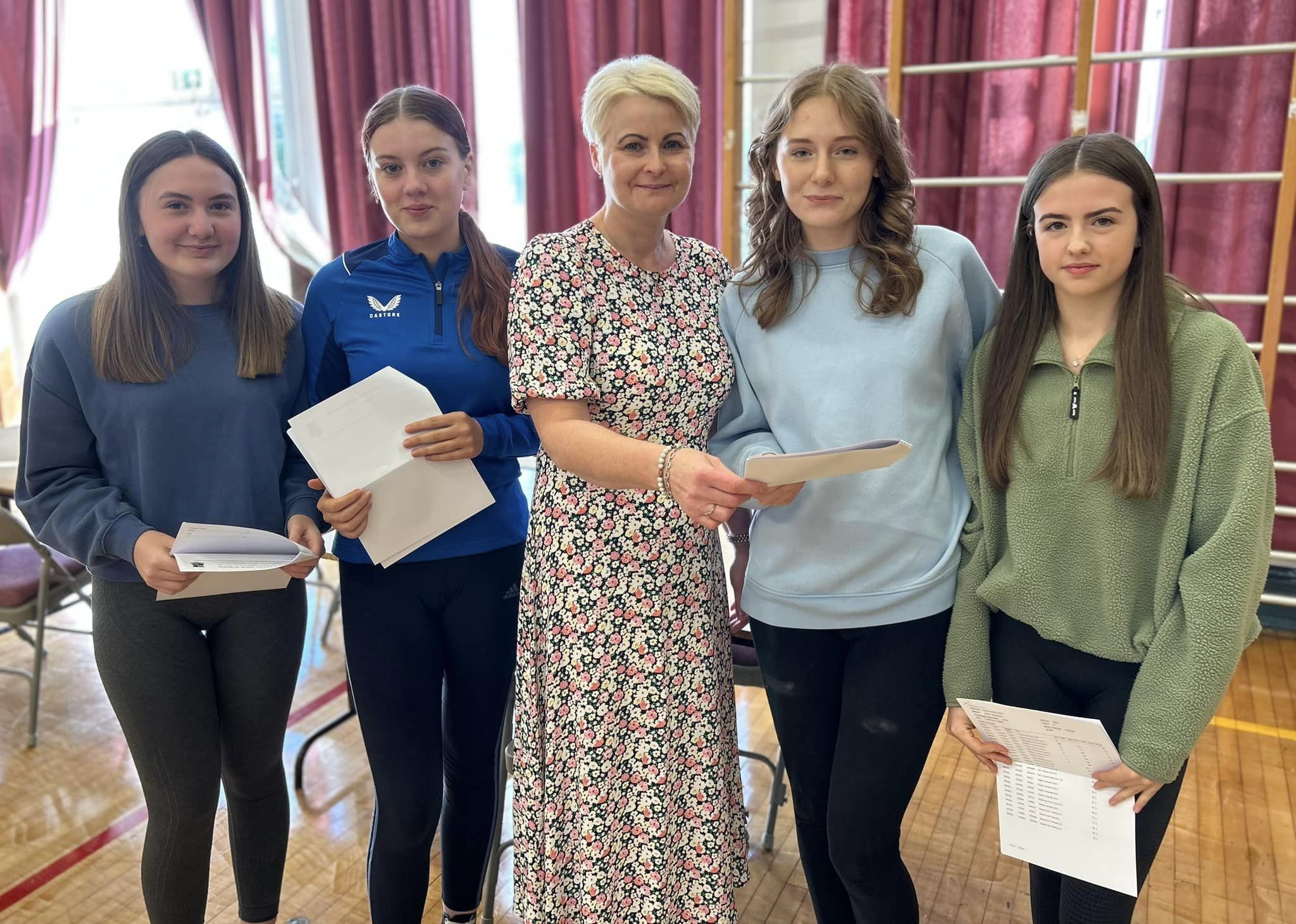 Castlederg High School students Molly Monteith, Amy Donnell, Rebecca Ellis and Abby Sherlock share their results with Mrs. Sandra Cashel, incoming Principal.
