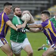 Sean Quigley tries to push his way through brothers Stephen and Shane McGullion.