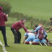 The Tummery players celebrate with Aidy McCaffrey after his spectacular late goal.