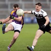 Ryan Jones gets a shot away as Celium Doherty closes in during the 2021 Ulster Club final.