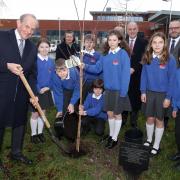 The Viscount Brookeborough, Her Majesty's Lord Lieutenant for County Fermanagh, planting a tree on The 70th Anniversary of The Accession to The Throne of Her Majesty Queen Elizabeth 11 at The Model School in Enniskillen. Also included are pupils