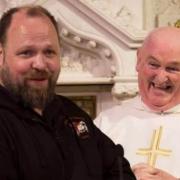 The late Kieran 'KB' Brennan and the late Fr. John Kearns taken on the altar of the memorial in 2019.