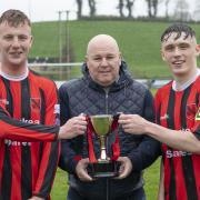 Niall Keenan and Jamie McCaffrey accept the winning tophy from Neil Jardine.