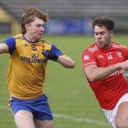 Conor McAuley is challenged by Josh Horan.