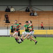 Tiarnan Daly and Mark Kelly battle for possession