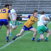 Martin McGrath shields the ball from Josh Horan as he tries to evade the tackle