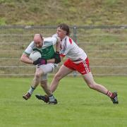 Clearing defence Conor Quigley comes under pressure from Paul Og O'Reilly