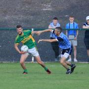 Irvinstown Kevin Duffy looks for support as he fends of Paul McGrath