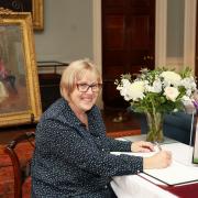 Marion Saunderson, signing the book of condolences in memory of Her Majesty Queen Elizabeth II in Castle Coole House.