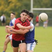 Luca McCusker gets the ball away as Conor McGowan attempted to close him down.