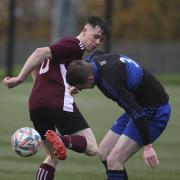 Lorcan McKenna with a backheel as Jonathan Browne tries to contain him against the sideline.
