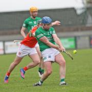Ryan Bogue makes contact with the sliotar before Niall Lennon can get a hook in.