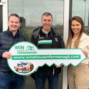 The winners of Fermanagh GAA's win a house draw Cathal and Cora McErlean are pictured with Club Eiren chairman Ger Treacy.