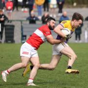 Conor Burns is bought to ground by Belnaleck's Kane Connor.