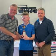 Ben McCaldin receiving his prize for winning the Topper event in Carrickfergus.