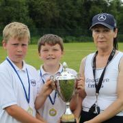 Tina Maxwell presents the Cadden Cup to the winners of the Kwik Cricket Tournament, Maguiresbridge PS A team.