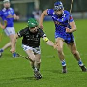 Tom Keenan races onto the dropping sliotar with Liam O'Brien closing in.