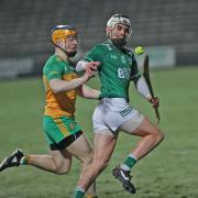 Luca McCusker keeps control of the sliotar with Oisin Kelly pressing.
