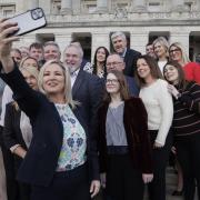 Northern Ireland First Minister Michelle O'Neill takes a photo with Sinn Féin party MLA colleagues on the steps of Parliament Buildings at Stormont. Photo: PA Wire.
