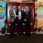 Alan Carroll of Allianz presents Liam Magee with the Fermanagh Cumann na mBunscol award with National Cumann na mBunscol Chairman Joe Lyons.