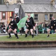 Members of Ballyshannon Rugby Club performing a haka at the roundabout by the Erne's waters.