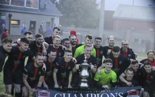 The Fivemiletown United players celebrate after securing the Marshall Cup.