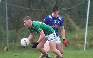 Nathan Beattie scoops the breaking ball before Oisin Maguire.