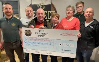 Pictured presenting a cheque for £2,150 are Mark Loughran (The Perfect Pint), Fabian McGlone (quiz master), Colin Bell (The Kevin Bell Repatriation Trust), Geraldine Wilson, Eileen McKenna, David McKenna and Paul McKenna (quiz organisers).